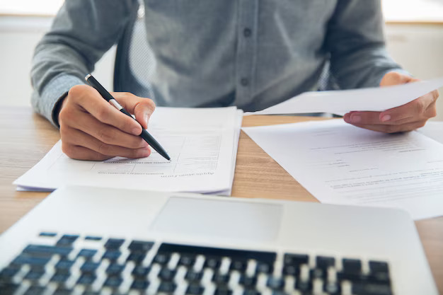 businessman-checking-documents-table_1262-2231